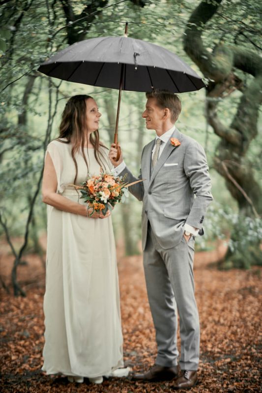 Eva, beautiful real bride under the rain in a Larimeloom wedding dress